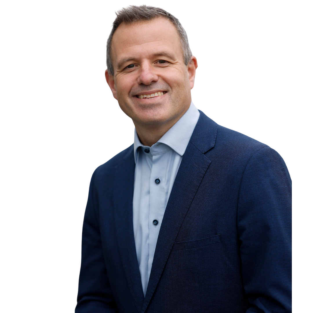 Head and shoulders shot of a smiling person wearing a navy blue jacket over a light blue shirt