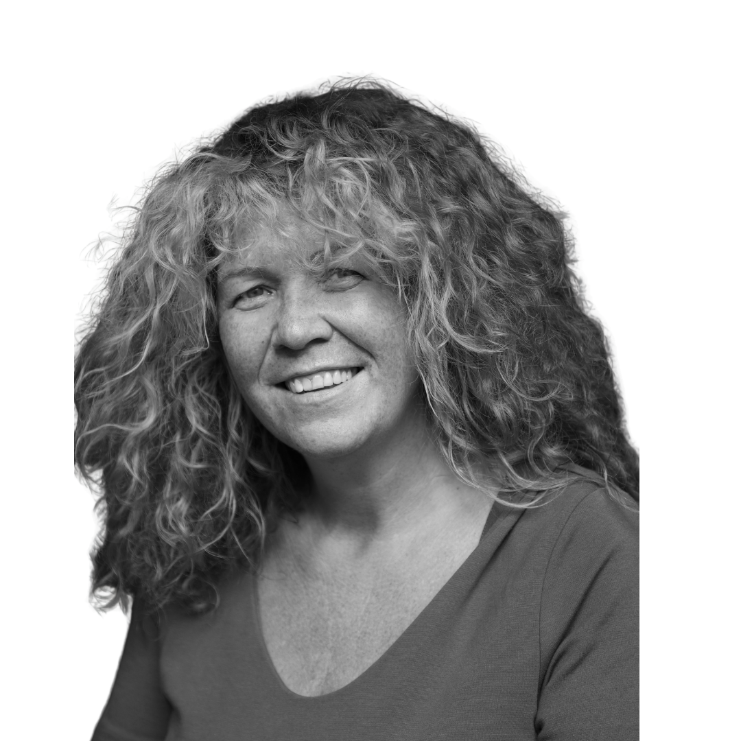 Black & White Head and shoulders shot of a smiling person wearing a dark coloured top