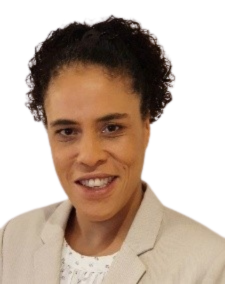Head and shoulders shot of a smiling person wearing a mushroom coloured jacket over a white top